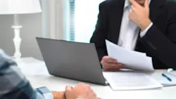 Mortgage broker looking over a mortgage application Mortgage broker looking over a mortgage application