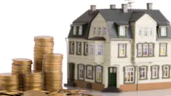 Model home sits next to coins, indicating household real estate value