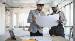 Builders look over house plan