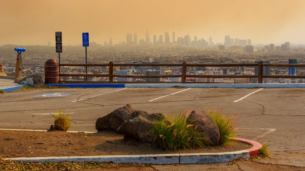 Los Angeles city skyline in orange haze caused by wildfire