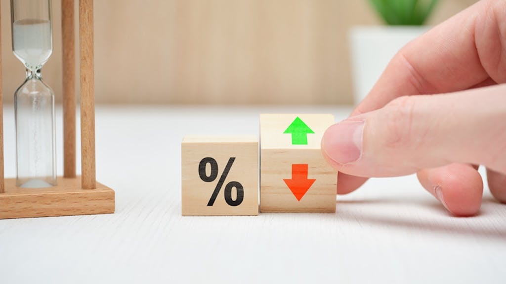 The concept of changing falling mortgage rates shown on wooden blocks