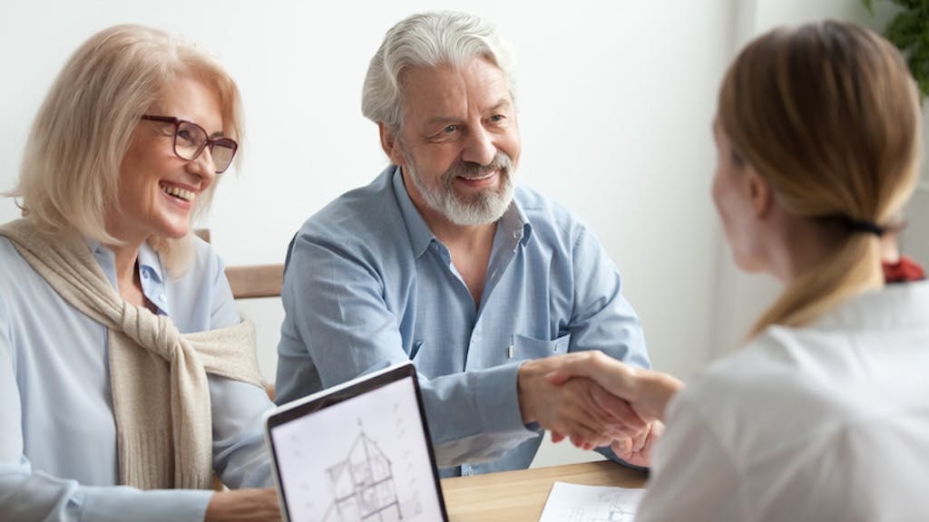 Retired couple meets with a real estate agent