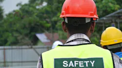 Construction worker wearing hard hat and safety vest