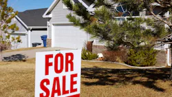 'For Sale' sign in front of single-family home