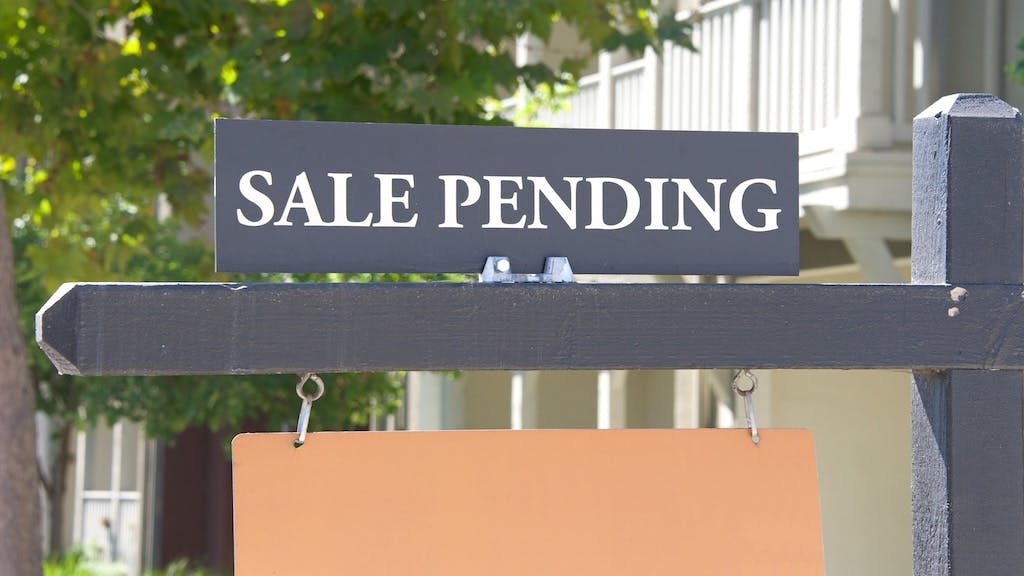 A sign in front yard reading 'Sale Pending'