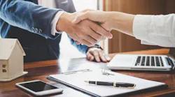 Homebuyer shakes hands with real estate agent after closing on a home