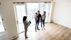 Young family tours a starter home with a real estate agent Young family tours a starter home with a real estate agent