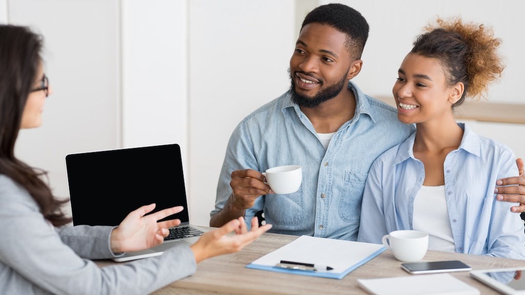 Millennial homebuyers meet with real estate agent