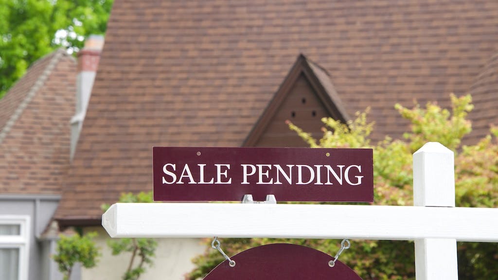 'Sale Pending' sign in front of single-family home