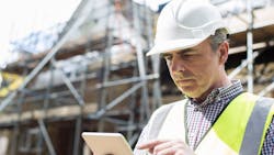 A builder multi-tasking at work A builder multi-tasking at work