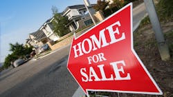 A red sign pointing to a home for sale A red sign pointing to a home for sale