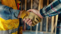 Two home builders shake hands Two home builders shake hands