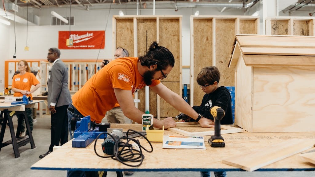 The Home Depot volunteer working with a participant during program event