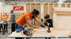 The Home Depot volunteer working with a participant during program event The Home Depot volunteer working with a participant during program event