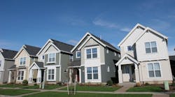A row of newly-constructed homes on a suburban street A row of newly-constructed homes on a suburban street