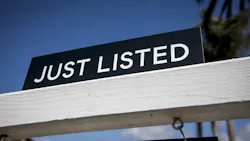 A closeup of a sign that reads 'Just Listed,' indicating that a home was made available for sale A closeup of a sign that reads 'Just Listed,' indicating that a home was made available for sale