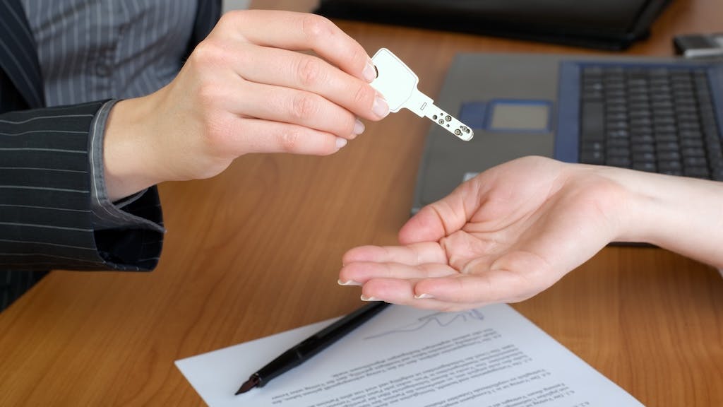 A homebuyer holds out hand for a house key