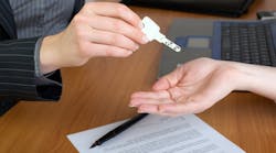 A homebuyer holds out hand for a house key A homebuyer holds out hand for a house key