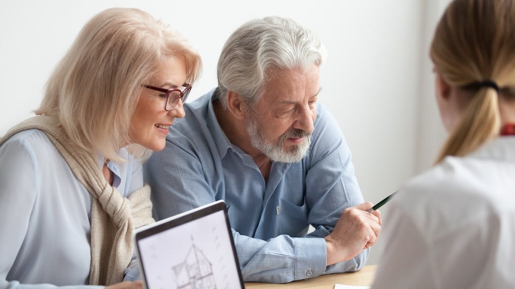 Older homebuyers looking over plans of a new home