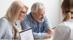 Older homebuyers looking over plans of a new home Older homebuyers looking over plans of a new home