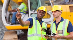 Construction workers collaborating at a jobsite Construction workers collaborating at a jobsite