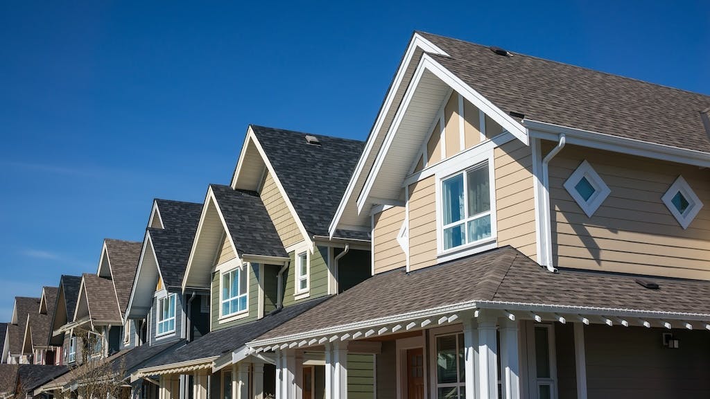 Row of townhomes against blue sky