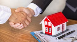 An investor shakes hands with a real estate agent after buying a home An investor shakes hands with a real estate agent after buying a home