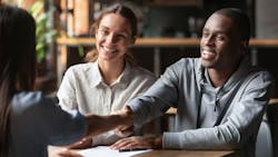 First-time homebuyers speak with a real estate agent First-time homebuyers speak with a real estate agent