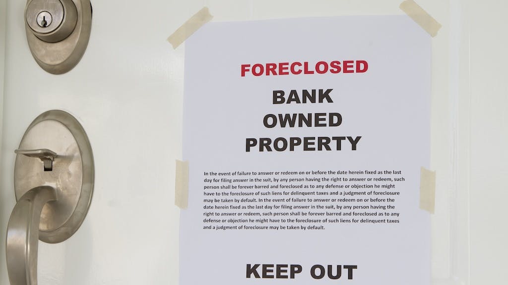 Foreclosure notice on the front door of a home