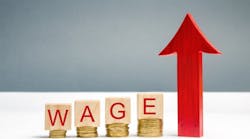 Wooden blocks with coins and the word 'wage' and an up arrow Wooden blocks with coins and the word 'wage' and an up arrow