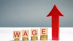 Wooden blocks with coins and the word 'wage' and an up arrow Wooden blocks with coins and the word 'wage' and an up arrow