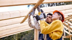 Female construction worker working alongside male coworker Female construction worker working alongside male coworker