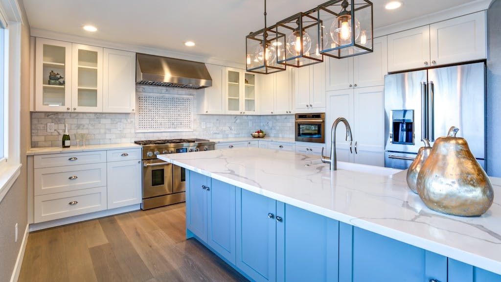 Blue kitchen island with drawer storage in white modern kitchen