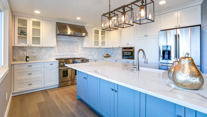 Blue kitchen island with drawer storage in white modern kitchen