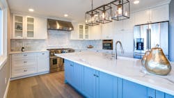 Blue kitchen island with drawer storage in white modern kitchen Blue kitchen island with drawer storage in white modern kitchen