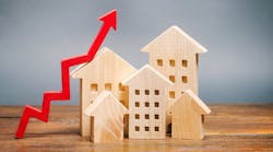 Wooden model homes with a red arrow pointing up, indicating price growth Wooden model homes with a red arrow pointing up, indicating price growth