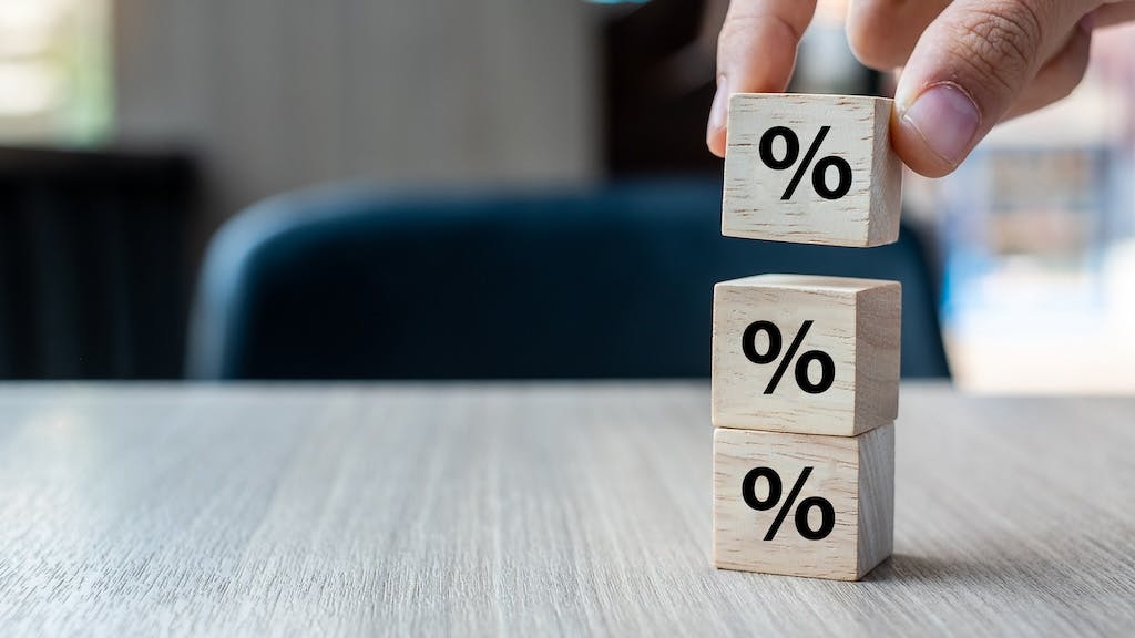Blocks with percentage signs stacked on top of each other, indicating climbing mortgage rates