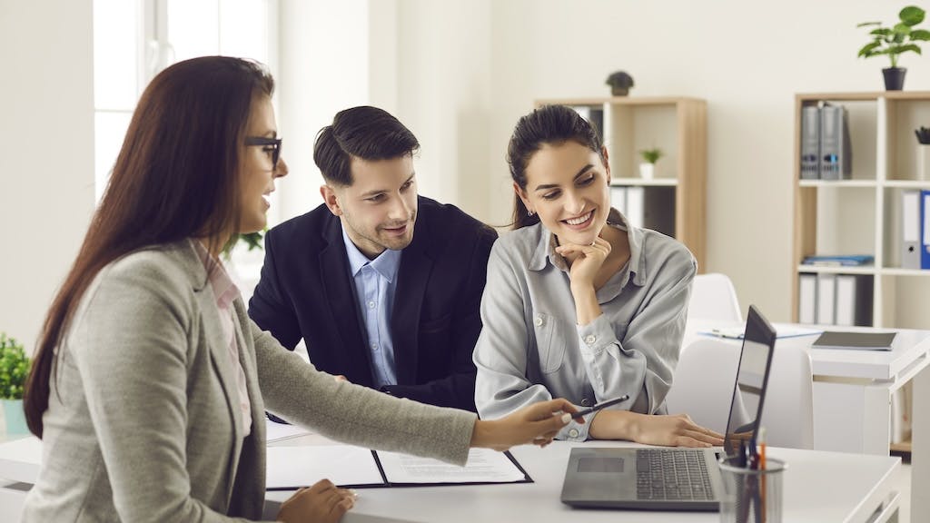 Real estate agent talking to a couple of homebuyers