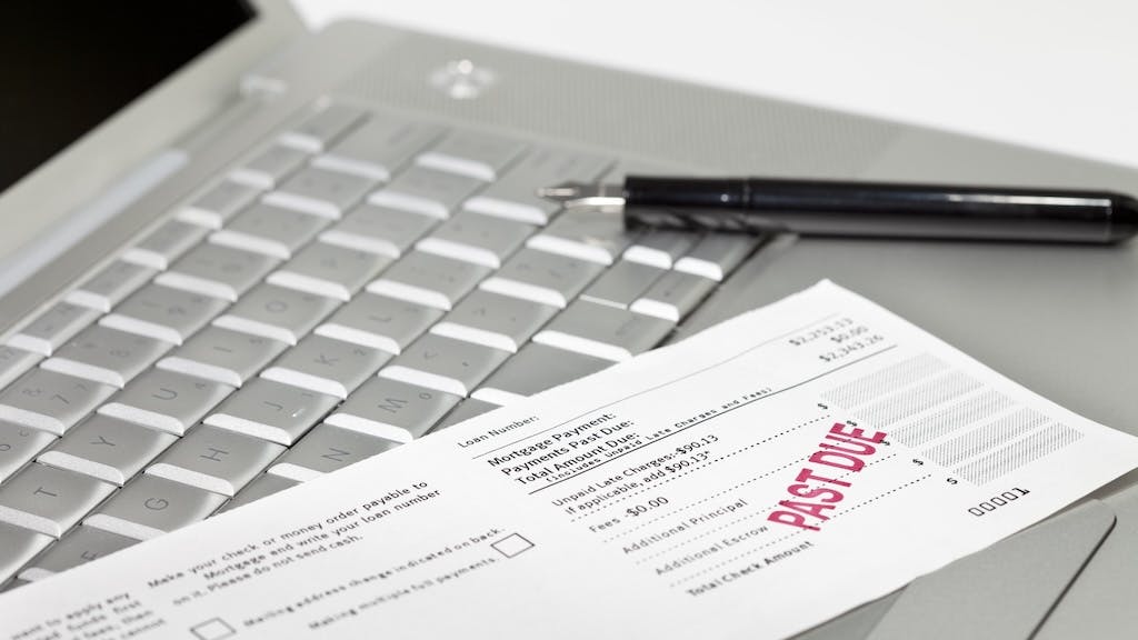 A mortgage payment notice with 'past due' stamped in red