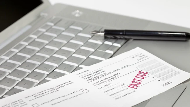 A mortgage payment notice with 'past due' stamped in red