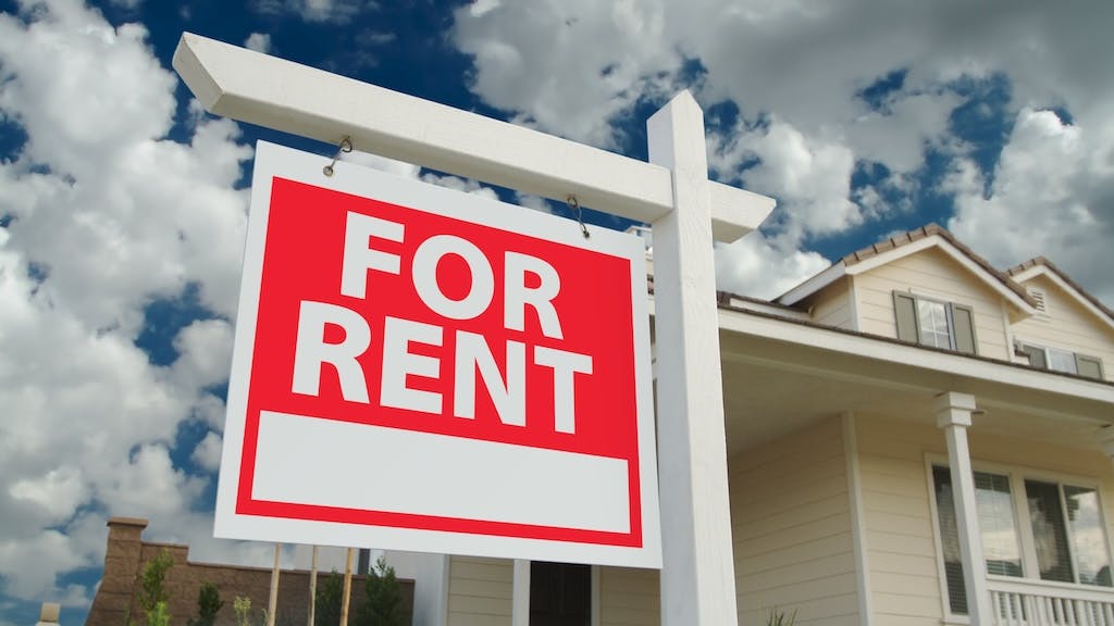'For Rent' sign in front of a home