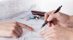 An architect works on house plan with a client An architect works on house plan with a client