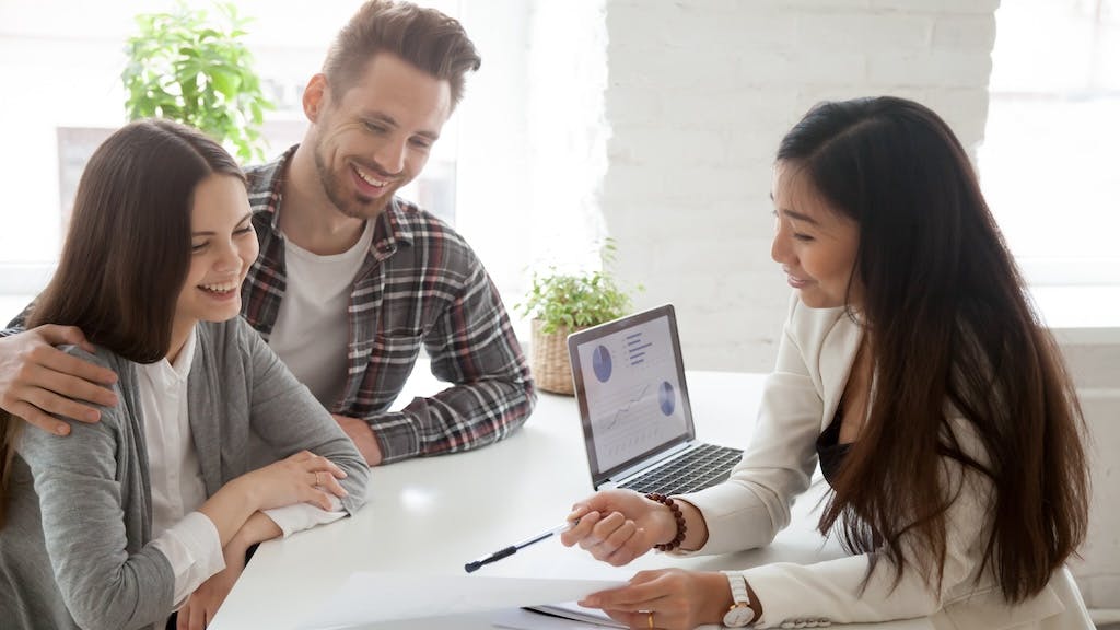 Young homebuyers speak to real estate agent