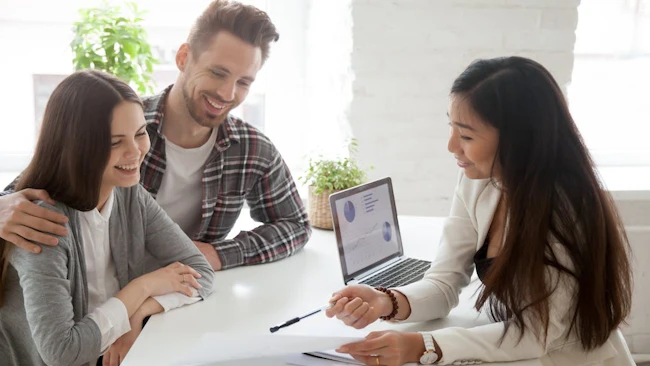 Young homebuyers speak to real estate agent