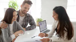 Young homebuyers speak to real estate agent