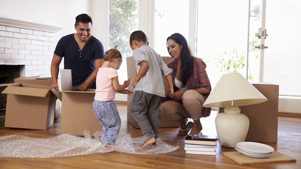 Family unpacking boxes at their new home