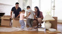 Family unpacking boxes at their new home