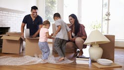 Family unpacking boxes at their new home Family unpacking boxes at their new home