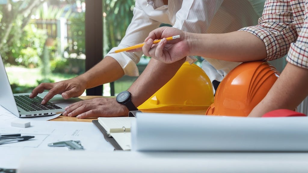 Home builders working on laptop together