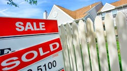 A 'sold' sign in front of a home A 'sold' sign in front of a home